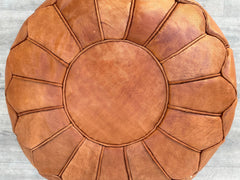 Elevate your home decor with authentic Moroccan leather poufs, handcrafted by skilled artisans using traditional techniques. These round or square ottomans feature premium goat or buffalo leather, dyed with natural pigments for rich, earthy tones. Perfect as footstools, extra seating, or bohemian accents, each pouf showcases intricate embroidery and durable stitching. Available stuffed or unstuffed, they blend versatility with luxury—ideal for living rooms, bedrooms, or outdoor spaces. Pair with a tray for 