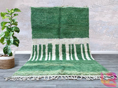 Enhance your space with this exquisite handmade Moroccan wool rug, crafted in the traditional Beni Ourain style. Featuring a soft green geometric pattern, this Berber carpet is woven by skilled artisans using natural wool for a durable yet plush texture. The abstract tribal design adds a bohemian charm to any room, making it perfect for modern, boho, or minimalist interiors. Whether placed in the living room, bedroom, or hallway, this authentic Moroccan rug brings warmth and cultural elegance to your home.