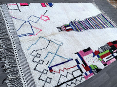 Discover the beauty of a handmade Moroccan Azilal rug, a stunning Berber wool carpet crafted by skilled artisans. This colorful traditional rug features vibrant abstract designs, blending rich hues and tribal patterns for a bohemian-chic aesthetic. Made from natural wool and cotton, each piece is unique, reflecting the heritage of Morocco’s Atlas Mountains. Perfect for adding warmth to living rooms, bedrooms, or boho-inspired spaces, this authentic Azilal rug is durable, soft, and ethically sourced. Availab