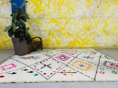 Upgrade your home with this hand-knotted Beni Ourain rug, crafted from 100% Moroccan wool for a soft, luxurious feel. Featuring a traditional Berber design, this custom-sized carpet adds a bohemian touch to any space—living room, bedroom, or nursery. Each rug is artisan-made by skilled Moroccan weavers, ensuring a unique, high-quality piece. Free shipping included! Perfect for boho, tribal, or eclectic decor. Explore our collection of Azilal, Boucherouite, and Kilim rugs for more authentic Moroccan handmade