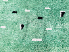 Elevate your home with a stunning handmade Moroccan green rug, crafted by skilled artisans using traditional Berber techniques. This authentic wool rug features a vibrant, earthy green hue, blending bohemian charm with timeless elegance. Each piece is handwoven with premium natural wool, ensuring durability and softness underfoot. Perfect for living rooms, bedrooms, or entryways, this Moroccan area rug adds warmth and texture to any space. The intricate geometric patterns reflect centuries of Berber heritag