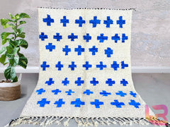 Discover the beauty of handmade Moroccan wool rugs from The Anou Cooperative, featuring fair trade craftsmanship. Our blue and white Berber rugs are pet-friendly, durable, and perfect for bedrooms, living rooms, or hallways. Available in custom sizes (8x10 ft, 6x9 ft, etc.), these Beni Ourain-style rugs blend traditional weaving techniques with modern boho aesthetics. Whether you prefer checkered patterns, abstract designs, or Azilal-inspired motifs, each rug is handwoven by Moroccan artisans. Shop on Etsy,