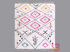 Transform your space with this large Berber rug, a handmade Azilal wool carpet showcasing intricate tribal designs and a luxuriously soft texture. Perfect for bohemian, rustic, or minimalist interiors, this versatile area rug adds warmth and cultural charm to any room. The durable wool construction ensures long-lasting beauty, while the hand-knotted craftsmanship highlights authentic Moroccan artistry. Whether used as a statement piece in the living room or a cozy hallway runner, this traditional Moroccan r