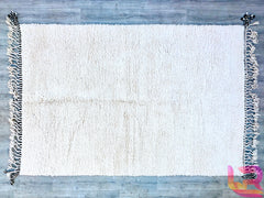 Enhance your space with this premium Beni Ourain Moroccan rug, a handwoven masterpiece from the Atlas Mountains. This 8.5 FT x 11.7 FT (8x12) rug is crafted from natural, undyed wool, offering a cloud-like softness underfoot. The minimalist black-and-white tribal patterns add sophistication to any room—ideal for Scandinavian, boho-chic, or eclectic interiors. Each rug is individually hand-knotted, ensuring a one-of-a-kind heirloom piece. The thick, fluffy pile provides insulation and comfort, making it perf