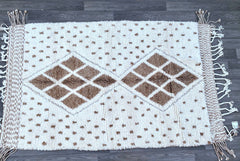 Elevate your home with luxury Beni Ouarain rugs from woolberber.com. Renowned for their soft, high-pile wool and minimalist designs, these Moroccan Berber carpets are handmade by indigenous weavers using centuries-old techniques. Ideal for living rooms, bedrooms, or statement decor, our rugs come in neutral tones (ivory, beige, brown) and customizable sizes. Ethically sourced and fair trade certified, each purchase supports artisan communities. Free shipping worldwide. Explore our collection of timeless, ha