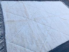Elevate your interior with a modern Beni Ourain-style rug, blending contemporary minimalism with traditional Berber weaving techniques. This handmade wool rug features a neutral ivory palette with subtle geometric accents, offering a versatile and elegant touch to any decor. Perfect for mid-century modern, farmhouse, or eclectic spaces, its plush, high-pile texture provides unmatched comfort underfoot. Sustainably crafted by skilled artisans, this eco-conscious carpet is a luxurious yet practical choice for