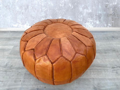 Upgrade your décor with sleek leather poufs and ottomans, designed for style and comfort. Whether you need a leather storage ottoman for blankets or a minimalist leather cube pouf, our selection includes top-grain leather, faux leather, and bonded leather options. Perfect as a coffee table alternative, footrest, or accent piece, these leather ottomans come in round, square, and rectangular shapes. Explore trendy colors like camel, espresso, and cream to match your interior. Durable, easy to clean, and space