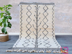 Enhance your décor with a premium handmade Moroccan Berber rug, featuring a classic tribal black-and-white pattern. Woven from 100% natural wool, this luxurious shag rug offers ultra-soft comfort underfoot while maintaining durability for high-traffic areas. The neutral tones and geometric motifs make it versatile for Scandinavian, bohemian, or contemporary interiors. Whether placed in a living room, bedroom, or entryway, this Moroccan wool rug brings a touch of global craftsmanship and organic texture to y