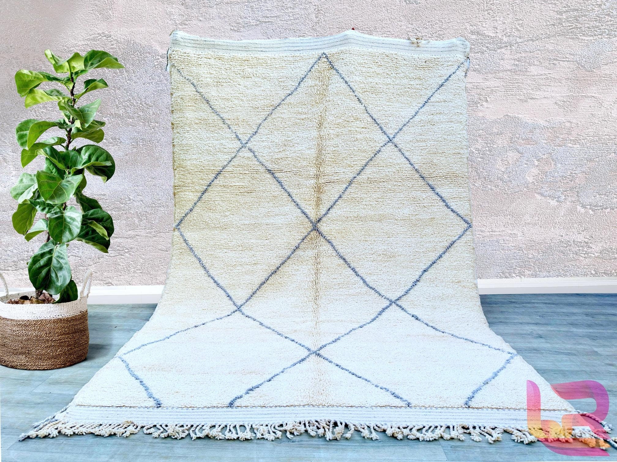 Elevate your space with this soft, plush Beni Ourain rug, a true representation of Moroccan craftsmanship. Woven by hand using premium wool, this Berber carpet features a subtle geometric pattern in neutral shades, blending seamlessly with boho, Scandinavian, or mid-century modern decor. The high-pile texture provides unmatched comfort underfoot, making it ideal for cozy living rooms or serene bedrooms. Each rug tells a story through its unique imperfections, ensuring a one-of-a-kind addition to your home. 