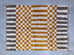 Elevate your décor with this handmade Moroccan Checkered Rug, inspired by the iconic Beni Ourain tribal designs. Featuring a vibrant orange and white checkerboard pattern, this Berber wool rug is soft underfoot and built to last. Each piece is custom-sized, making it ideal for any room—living spaces, nurseries, or entryways. The natural sheep wool ensures warmth and durability, while the tribal geometric motif adds a touch of exotic charm. Free shipping included! A perfect blend of bohemian flair and minima