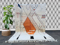 Bring a touch of Moroccan heritage into your home with this exquisite handmade Azilal rug. Woven by skilled Berber artisans, this unique piece features vibrant colors and intricate tribal patterns, reflecting centuries-old traditions. Crafted from 100% natural wool, this durable and soft rug adds warmth and character to any space. Perfect for bohemian, eclectic, or modern interiors, this one-of-a-kind Azilal rug is a statement piece that blends artistry and functionality. Whether used as a hallway runner, l
