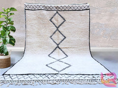 Elevate your home decor with this vintage Azilal Berber-style handmade rug, featuring a colorful abstract pattern that adds a playful yet sophisticated touch. Woven from premium Moroccan wool, this rug is soft, durable, and full of texture, making it ideal for high-traffic areas. The tribal-inspired motifs tell a story of heritage and craftsmanship, perfect for bohemian, eclectic, or modern interiors. Whether used as a statement floor piece or a cozy bedroom accent, this rug brings warmth and artistic flair