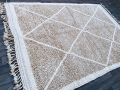 Introduce warmth and sophistication to your home with this vintage-inspired Beni Ourain rug, handcrafted from pure wool. Known for its minimalist yet striking geometric patterns, this Berber carpet adds a touch of understated elegance to any space. The plush texture and neutral palette make it versatile for living rooms, bedrooms, or even as a statement wall hanging. Each rug is uniquely handmade, ensuring no two pieces are alike. A perfect choice for those seeking a blend of tradition, comfort, and timeles