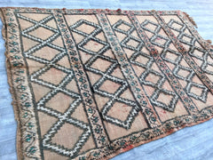 Enhance your decor with this luxurious vintage Beni Ourain rug, a classic example of Moroccan Berber craftsmanship. Made from soft, undyed wool, this handwoven rug features a minimalist diamond pattern and a plush, high-pile texture. Its neutral palette and organic imperfections create a cozy, inviting atmosphere, perfect for living rooms, bedrooms, or meditation spaces. A timeless investment, this tribal rug combines elegance and authenticity, making it a must-have for lovers of global-inspired design.