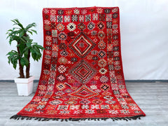 Crafted with care, this 6x10 ft vintage Moroccan rug showcases the finest hand-knotted wool, embodying centuries-old weaving traditions. The Berber tribal motifs, influenced by Boujaad and Azilal heritage, tell a story of nomadic artistry. The natural wool fibers provide softness underfoot while ensuring longevity. Ideal for bohemian, rustic, or modern interiors, this rug blends seamlessly into any décor. Its faded hues and aged texture enhance its antique appeal, making it a sought-after collector’s item. 