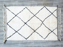 A true collector’s piece, this vintage Moroccan Berber rug showcases traditional craftsmanship with its intricate diamond and line patterns. Woven by skilled artisans using natural wool, this durable yet soft carpet is perfect for high-traffic areas. The neutral color palette ensures it complements a variety of decor styles—from Scandinavian minimalism to eclectic boho. Ideal as a living room centerpiece, bedroom accent, or statement wall hanging, this handmade rug adds cultural richness and textural depth 