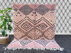 Enhance your home with a vintage Moroccan Boujad rug, a stunning handmade tribal carpet featuring rich, faded hues and traditional Berber symbols. These authentic wool rugs are woven by skilled artisans, showcasing unique patterns that tell a story of heritage and craftsmanship. The bohemian design blends seamlessly with mid-century, rustic, or contemporary interiors, adding warmth and character to any room. The distressed, time-worn look gives it a one-of-a-kind appeal, making each piece truly special. Per