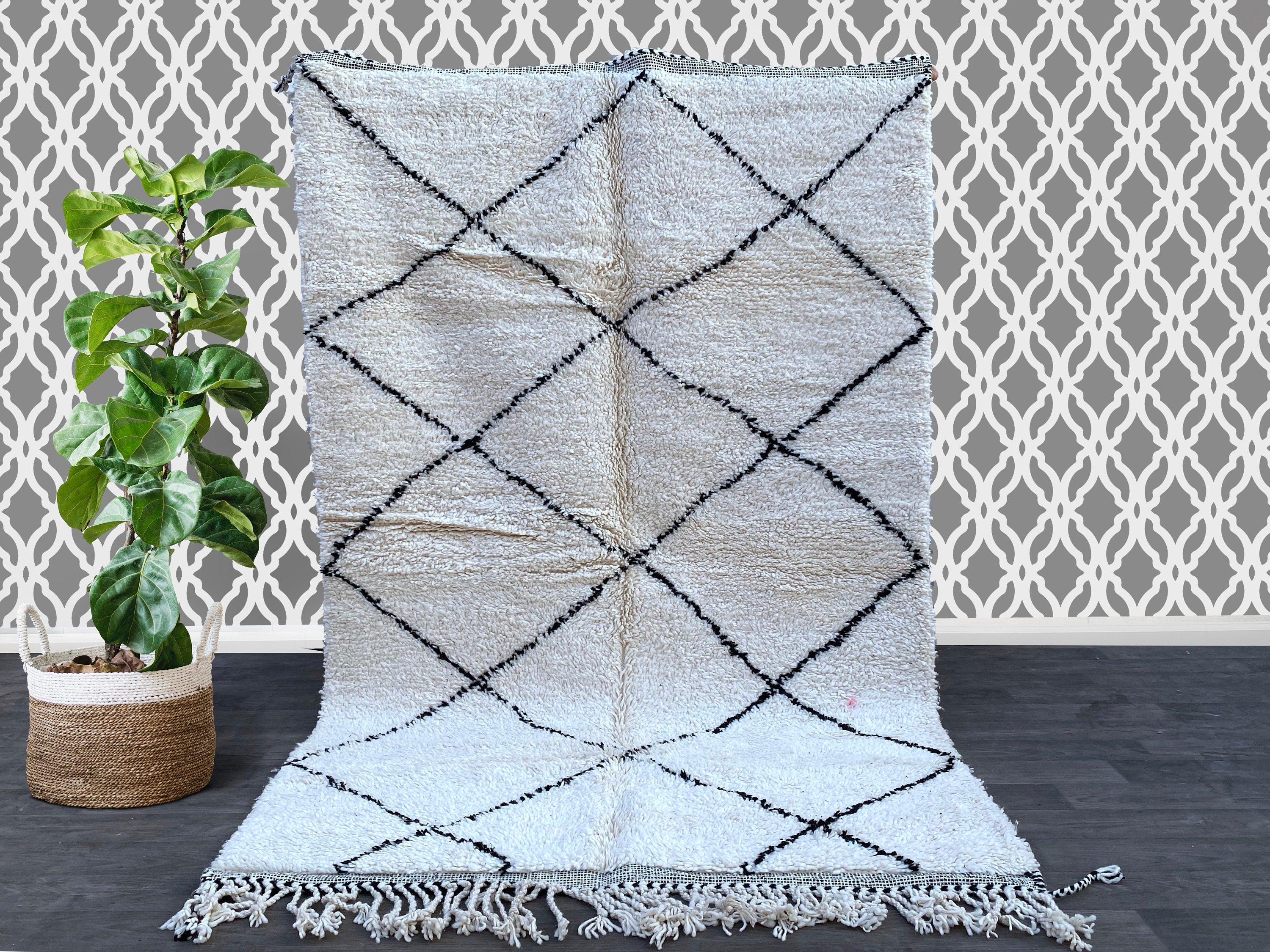 Discover the charm of a vintage Moroccan rug, featuring Beni Ourain, Azilal, and Boucherouite designs for a truly bohemian home decor statement. Each handmade Berber rug is woven from 100% natural wool, offering plush texture and tribal geometric patterns in neutral tones. Ideal for Scandinavian, boho-chic, or eclectic spaces, these Moroccan carpets add warmth and artistry to any room. Choose from small 4x6 rugs to large 8x10 statement pieces, or request a custom-sized Moroccan area rug. Perfect as a unique