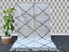 Discover the charm of a vintage Moroccan rug, featuring Beni Ourain, Azilal, and Boucherouite designs for a truly bohemian home decor statement. Each handmade Berber rug is woven from 100% natural wool, offering plush texture and tribal geometric patterns in neutral tones. Ideal for Scandinavian, boho-chic, or eclectic spaces, these Moroccan carpets add warmth and artistry to any room. Choose from small 4x6 rugs to large 8x10 statement pieces, or request a custom-sized Moroccan area rug. Perfect as a unique