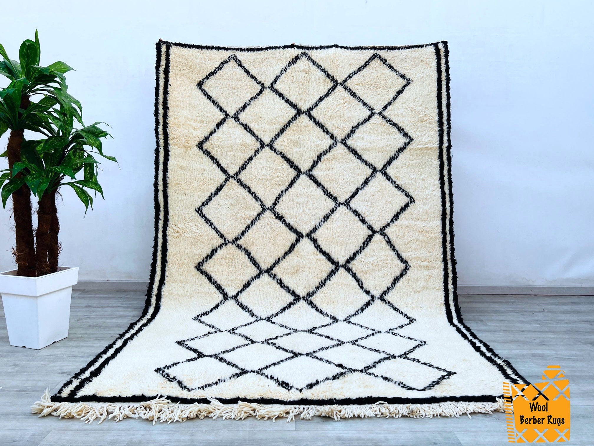 Elevate your home with this genuine vintage Berber rug, showcasing intricate tribal motifs and organic wool craftsmanship. Each piece tells a story through its unique patterns, reflecting centuries-old weaving traditions. The neutral tones and distressed finish create a rustic yet refined look, perfect for adding texture to minimalist or eclectic spaces. Whether layered over hardwood floors or paired with modern furniture, this Moroccan boujad rug brings warmth and cultural charm. Hand-knotted with premium 