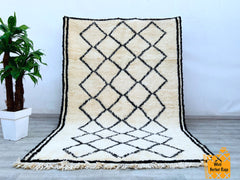 Elevate your home with this genuine vintage Berber rug, showcasing intricate tribal motifs and organic wool craftsmanship. Each piece tells a story through its unique patterns, reflecting centuries-old weaving traditions. The neutral tones and distressed finish create a rustic yet refined look, perfect for adding texture to minimalist or eclectic spaces. Whether layered over hardwood floors or paired with modern furniture, this Moroccan boujad rug brings warmth and cultural charm. Hand-knotted with premium 