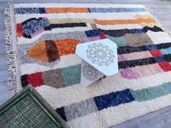 Enhance your home with a handmade Moroccan Beni Ourain rug, a luxurious Berber carpet woven from 100% natural wool. These authentic Moroccan rugs showcase geometric patterns and tribal motifs, crafted by women artisans in the Atlas Mountains. Ideal for boho, mid-century, or minimalist interiors, our Beni Ourain-style rugs come in custom sizes and colors, from classic black-and-white to vibrant multicolor designs. Each handwoven Moroccan rug is durable, hypoallergenic, and adds a cozy texture to floors. Pair